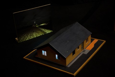 A doll's house and a photograph of a house at night